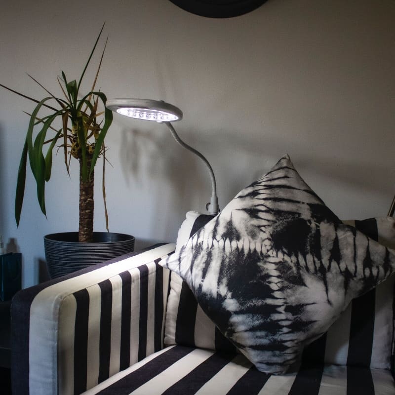 Schwarz-weiß gestreifte Couch mit Kissen für die LED-Lupenleuchte 4 in 1